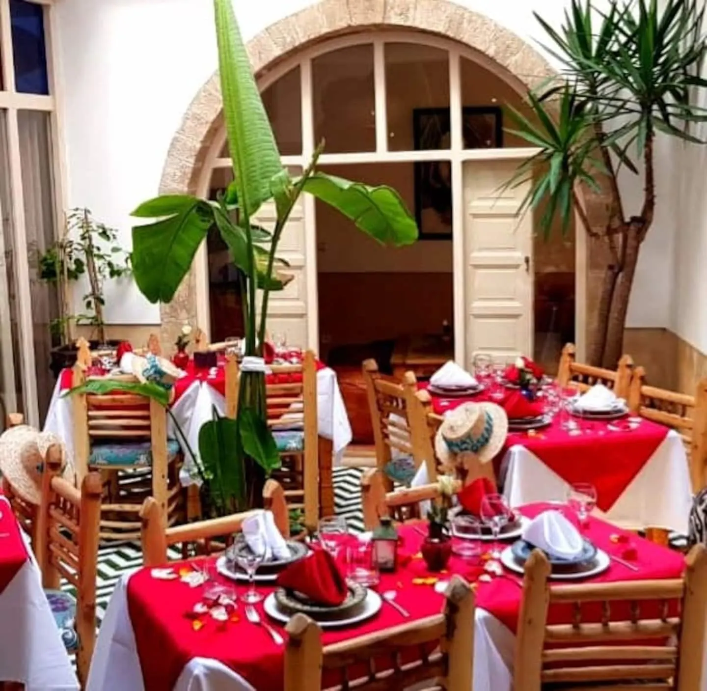 Patio dining corner with lanterns and red chairs