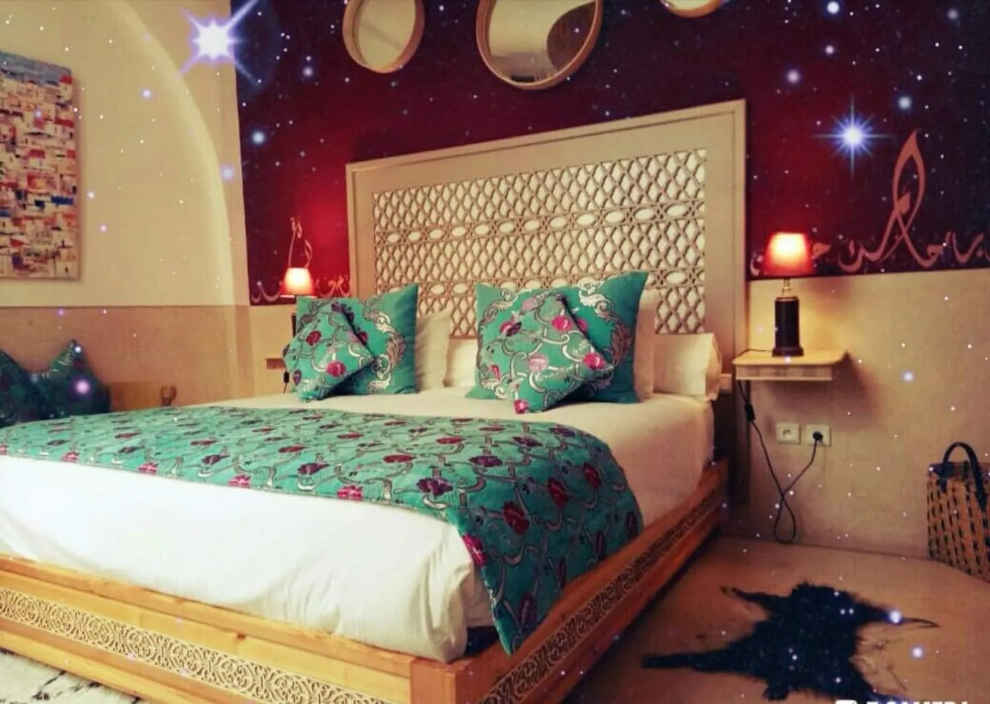 A bedroom with teal bedding and a white headboard
