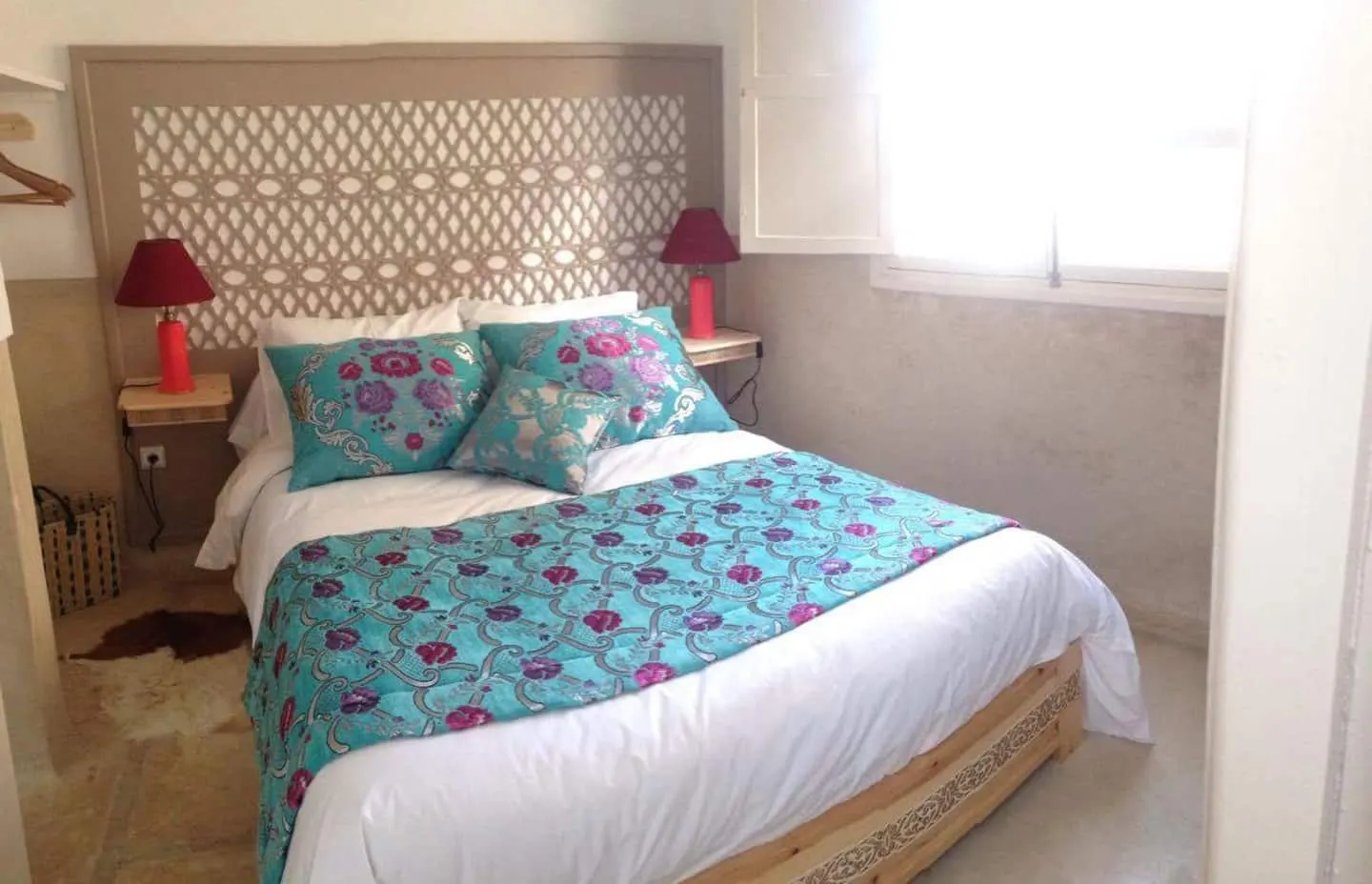 Bedroom with a cream upholstered headboard