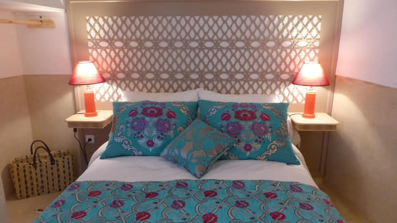 A bedroom with a carved wooden headboard