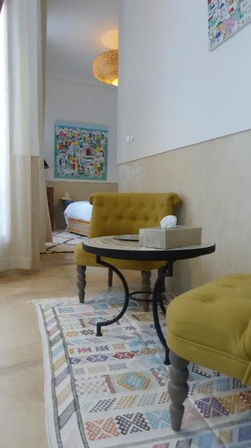 A quiet reading corner with yellow and teal armchairs